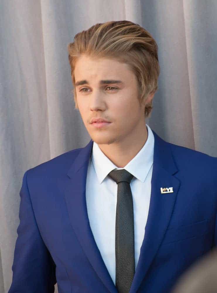 Justin Bieber combs back his hair the Comedy Central Roast of Justin Bieber at Sony Studios, Culver City in 2015.