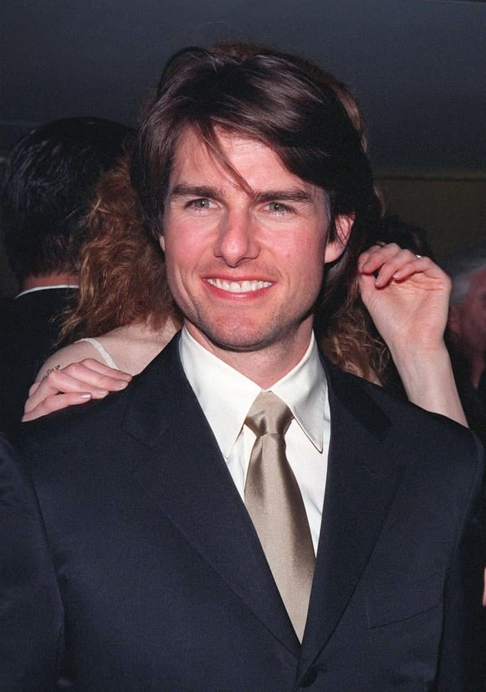 Actor Tom Cruise was practically glowing with pride at the Beverly Hilton Hotel where he was honored with the 1998 John Huston Award by the Artists Rights Foundation. He wore a dark suit with his long side-swept hairstyle.