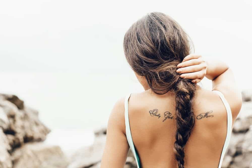 Woman on the shore with a braided hair.