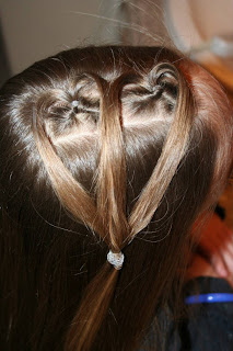 Top view of young girl having her hair styled as "teen heart" hairstyle 2