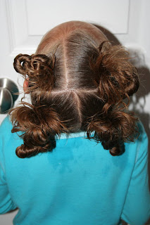 Back view of young girl modeling "4 Messy-Pigtail Twists" hairstyle