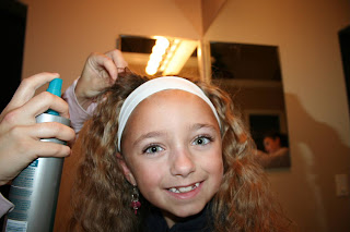 Front view of Young girl's 2nd Day Curls from Double-French Braids being styled