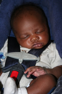 Infant baby boy sleeping in car seat