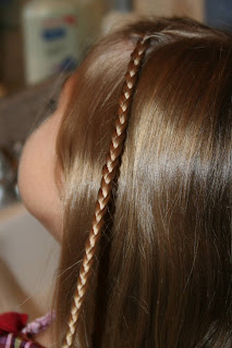 Side view of young girl's hair being styled into "Beachy Combo" hairstyle