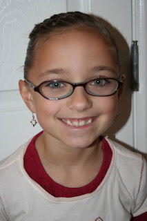 Portrait of young girl modeling "Hair Twists into Messy Buns" hairstyle 