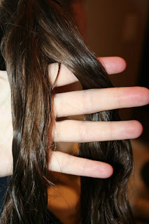 Close up of young girl's hair being styled into "Best Three-Leaf Clover" hairstyle