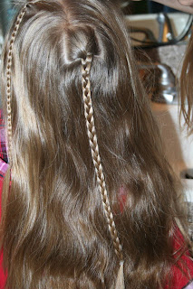 Back view of young girl's hair being styled into "Beachy Combo" hairstyle