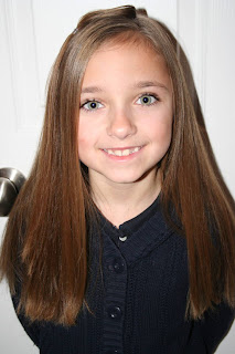 Portrait view of young girl modeling "teen heart" hairstyle 1