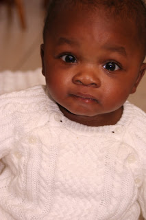 Young infant boy wearing a white sweater