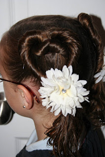 Side view of a young girl outside modeling “Two Hearts Twist” hairstyle