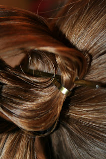 Close up view of young girl's hair being styled into "Teen Hair Bun" hairstyle