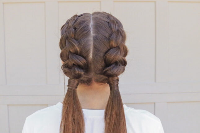 Back close up shot of girl with long brown hair standing outside modeling the "Double Dutch Wrap" hairstyle