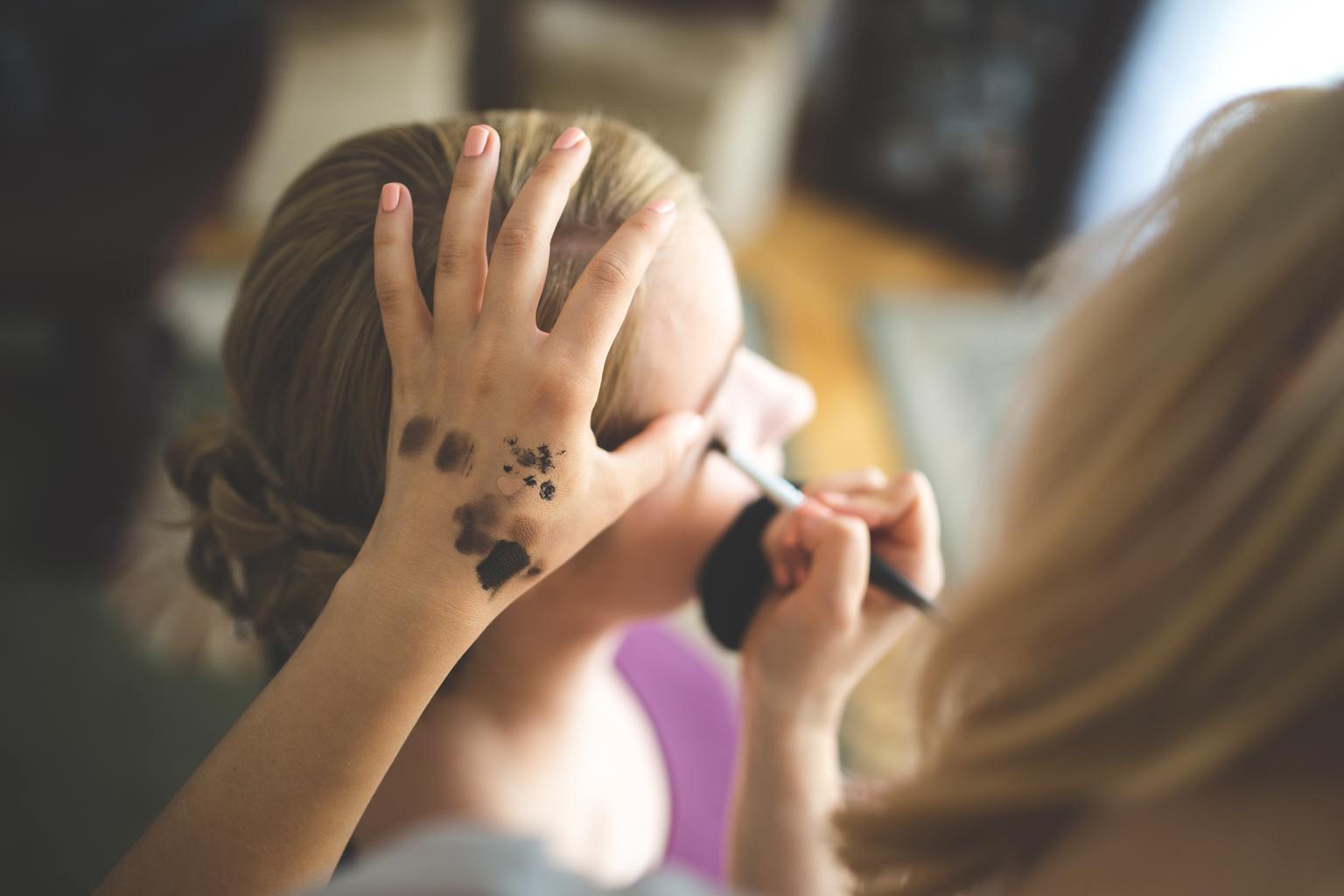 Women doing eyebrow makeup.