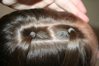 Top view of young girl having her hair styled as "teen heart" hairstyle 2