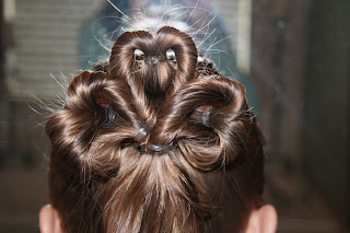 Back view of young girl modeling "Three-Leaf Clover Twists" hairstyle