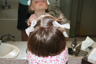 Back view of young girl modeling "twisty buns" hairstyle