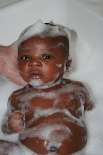 Infant baby boy in a bubble bath