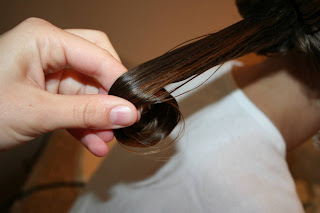 Close up view of young girl's hair being styled into "Teen Hair Bun" hairstyle