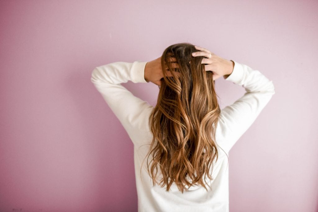 Stock photo of a woman running her hands through her hair