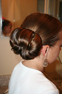 Side view of young girl's hair being styled into "Teen Hair Bun" hairstyle