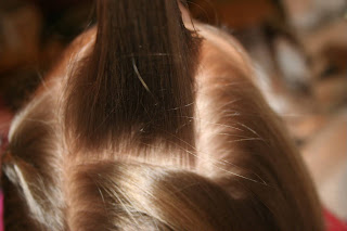 Top view of young girl's hair being styled into "Beachy Combo" hairstyle