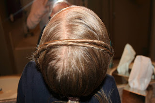 Top view of young girl's hair being styled into "Hair Headband" hairstyle