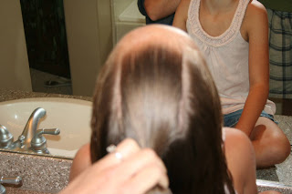 Girl's hair being styled into "Double Knot Ponytail"