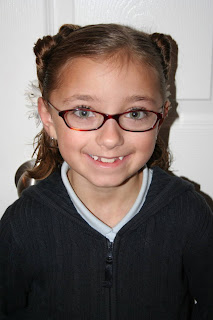 Portrait of a young girl modeling “Two Hearts Twist” hairstyle