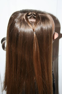 Side view of young girl modeling "teen heart" hairstyle 1