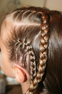 Side view of girl's hair being styled in "Criss-Cross French Braids"