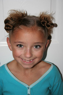 Portrait of young girl modeling "4 Messy-Pigtail Twists" hairstyle