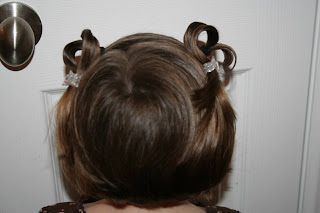 Back view of a young girl outside modeling “Heart Pigtail” hairstyle