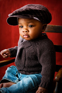 Infant baby boy in matching sweater and hat