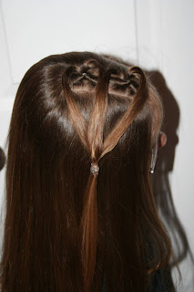 Side view of young girl modeling "teen heart" hairstyle 2