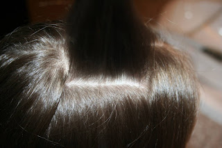 Top view of young girl having her hair styled as "teen heart" hairstyle 1