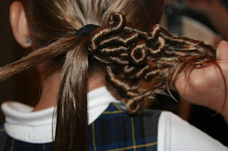 Young girl's hair being styled in to "Ponytail Of Twists" hairstyle