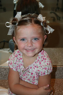 Portrait of young girl modeling "twisty buns" hairstyle