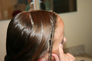 Young girl's hair being styled into "Triple Twists and Messy Buns"