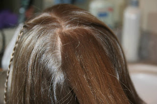 Back view of young girl's hair being styled into "Beachy Combo" hairstyle