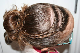 Top view of young girl modeling "Hair Twists into Messy Buns" hairstyle 