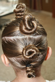 Back view of young girl modeling "The Bun-Hawk" hairstyle