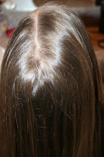 Top view of young girl having her hair styled as "teen heart" hairstyle 1