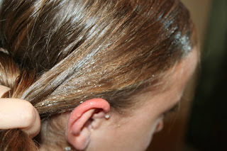 Side view of young girl's hair being styled into "Wrap-Around French Braid" hairstyle