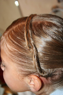 Side view of young girl's hair being styled into "Hair Headband" hairstyle