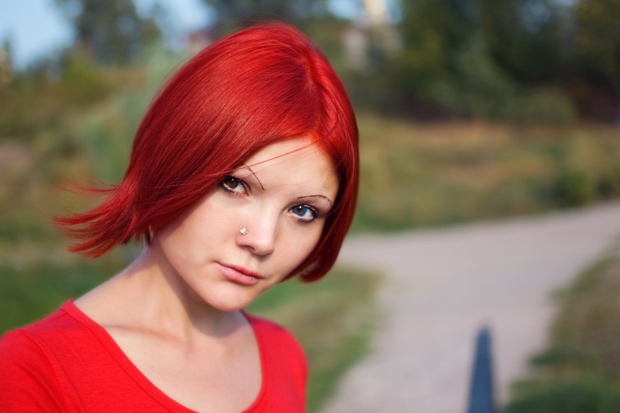 sleek red asymmetrical bob cut