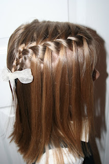 Side view of young girl modeling waterfall braid hairstyles