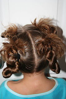 Back view of young girl modeling "4 Messy-Pigtail Twists" hairstyle