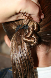 Young girl's hair being styled in to "Ponytail Of Twists" hairstyle