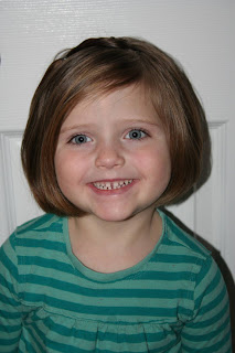 Portrait view of young girl modeling "teen heart" hairstyle 4