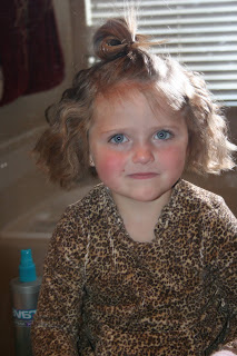 Portrait of young girl's hair being styled into 3-barrel curl hairstyle on her a-line bob